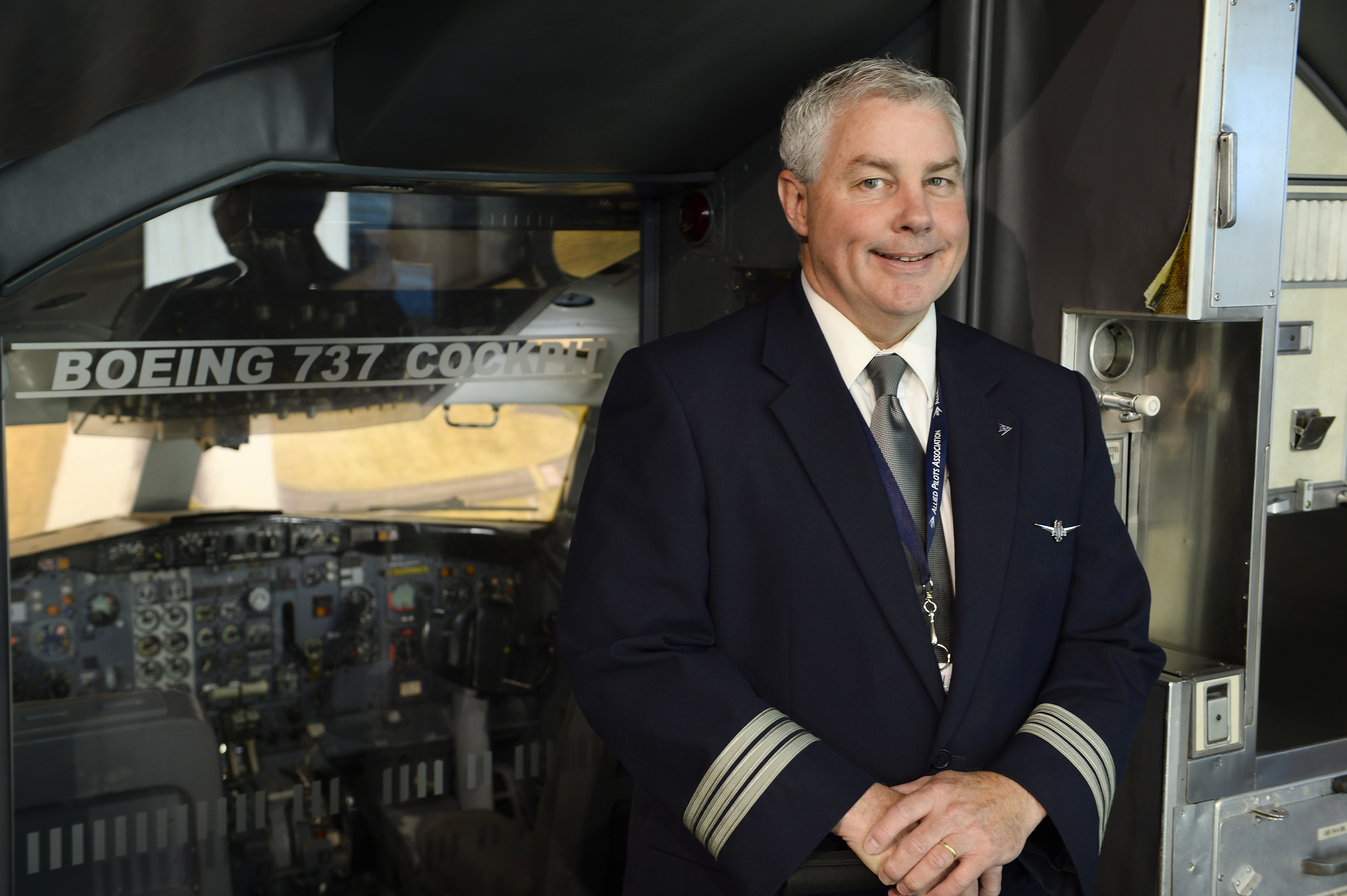 Former rusty pilot Steve Clarke pauses for photos near a mockup of a Boeing 737 cockpit at Baltimore/ Washington International Thurgood Marshall Airport. Photo by David Tulis.    