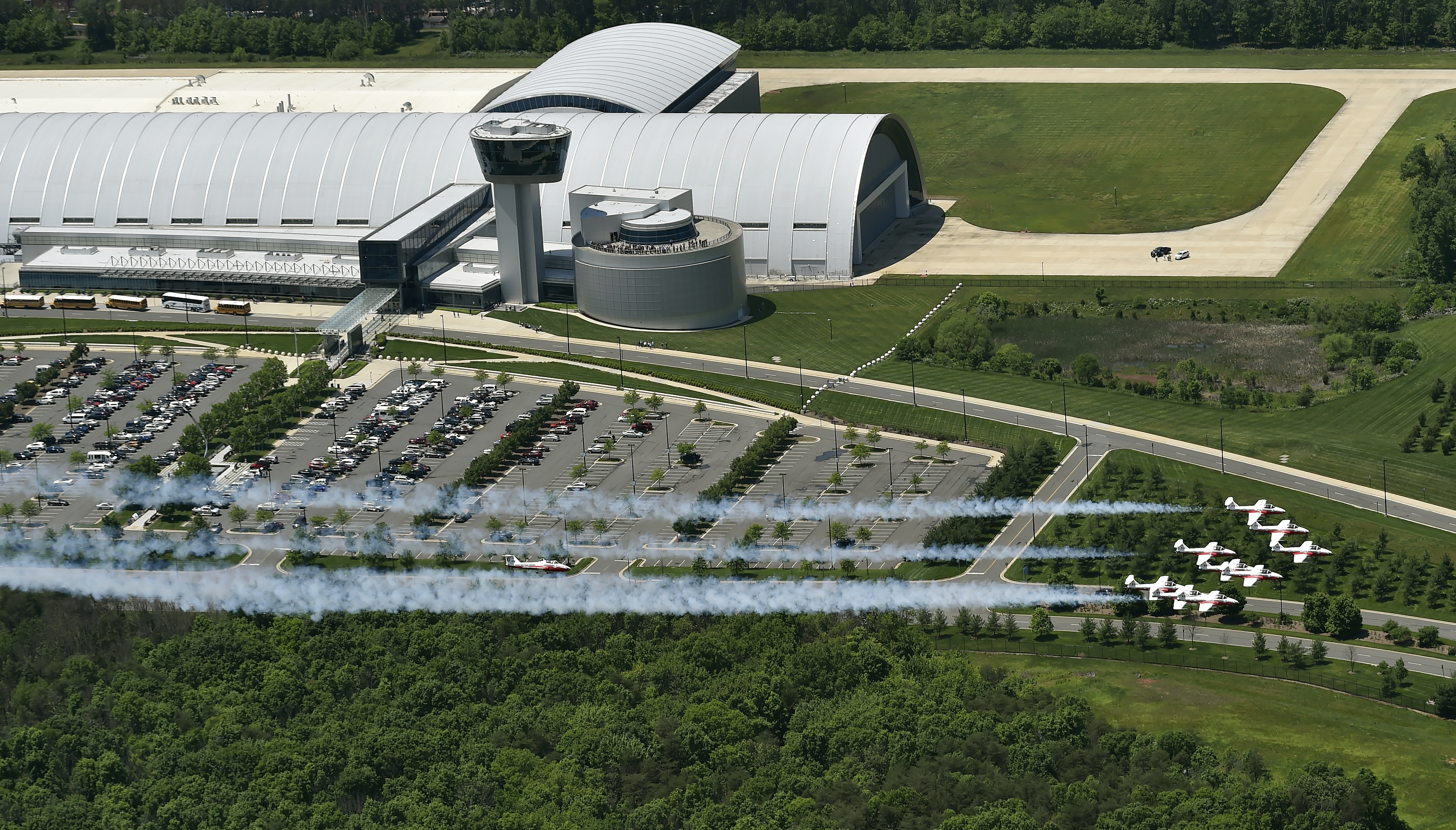 The Canadian Snowbirds aerial demonstration team flies in formation past the Steven F. Udvar-Hazy Center aviation museum during a nine-ship landing. Photo by David Tulis.                 