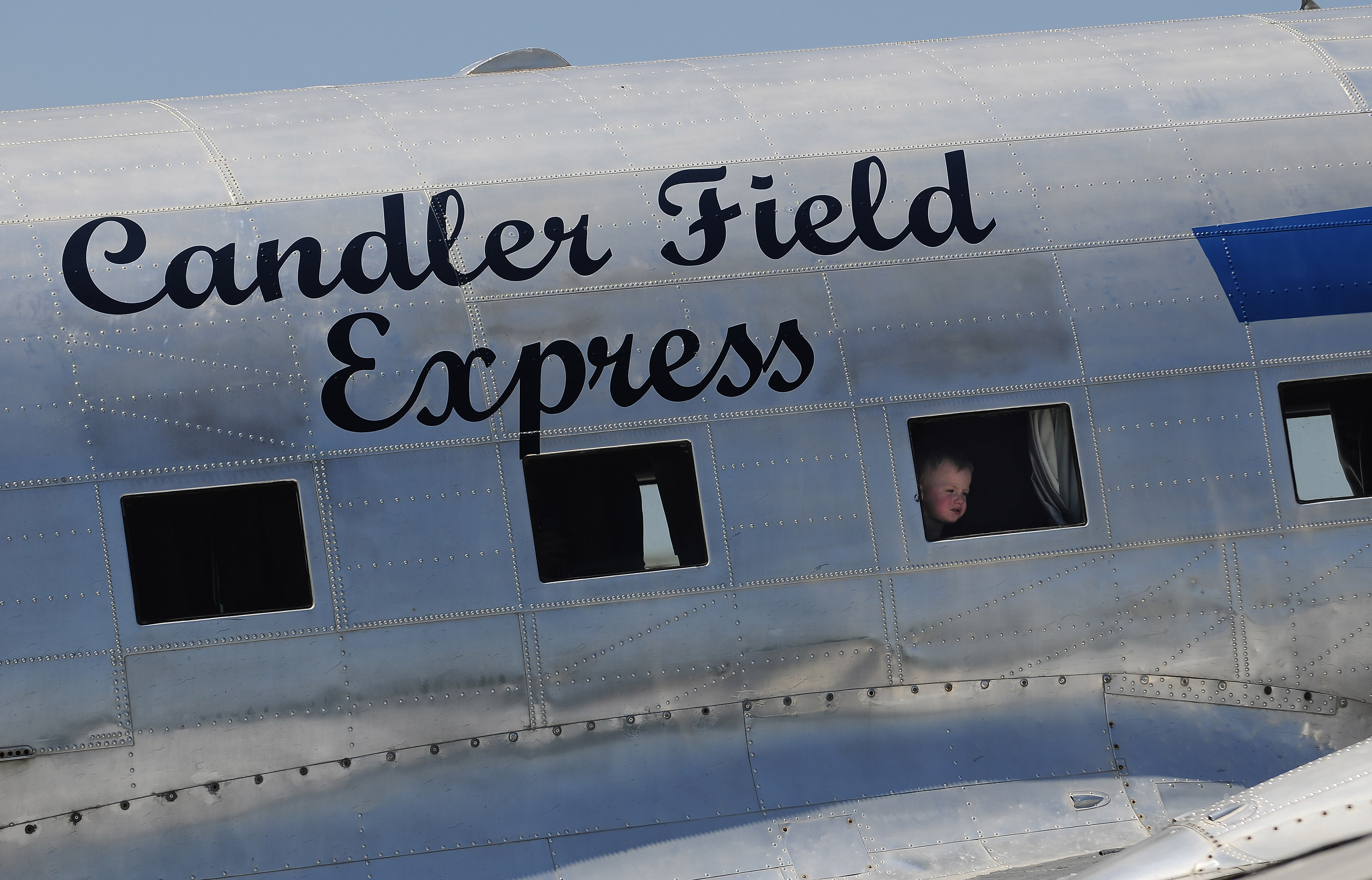 The 'Candler Field Express' DC-3 owned by Ron Alexander provides an interesting view for a young aviator during Peach State Aerodrome's 2011 Vintage Day celebration in Williamson, Georgia. Photo by David Tulis.