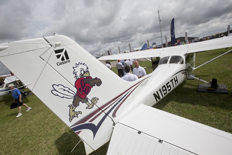 Textron Aviation Vice President of Piston Aircraft Doug May (facing camera) chats during a press event celebrating the Top Hawk program in 2015. AOPA file photo.