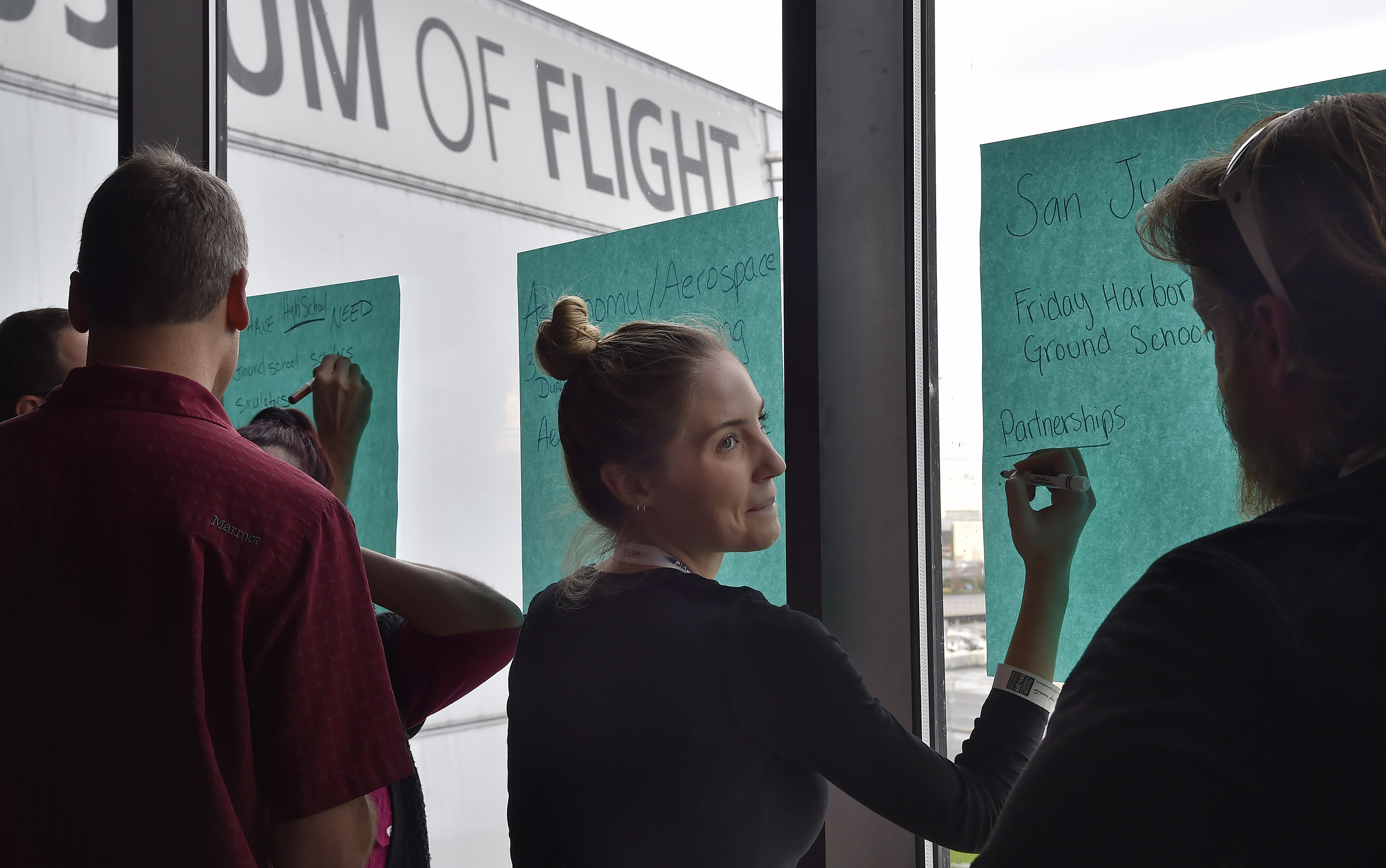 Educators Mari Peterson and Derek Smith write down the resources they now have in their schools and what they would ideally need to teach STEM-based aviation programs to their students during the AOPA High School Symposium in Seattle, Nov. 7. Photo by David Tulis.