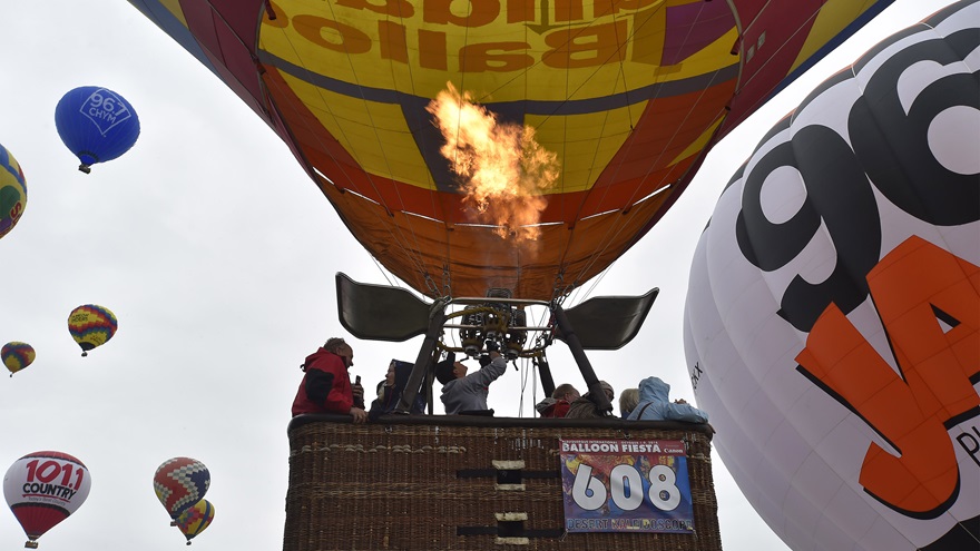 Balloonists lift off from ride row with baskets that can hold between 10 and 12 paying passengers during the Albuquerque International Balloon Fiesta, Oct. 8. Photo by David Tulis.