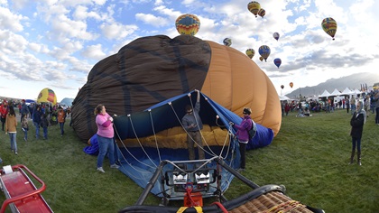 Ground crew members help inflate a balloon during the 45th Albuquerque International Balloon Fiesta in Albuquerque, New Mexico. Photo by David Tulis.