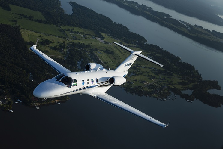 A Cessna Citation M2 flies over the countryside. Photo by Mike Fizer.