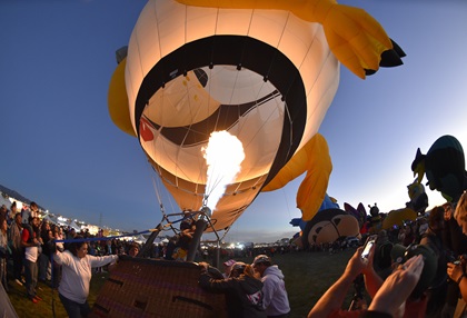 Spectators get close to balloons at a Special Shape Glowdeo where balloons are tied to static lines and light up the night sky during the Albuquerque International Balloon Fiesta, Oct. 6. Photo by David Tulis.