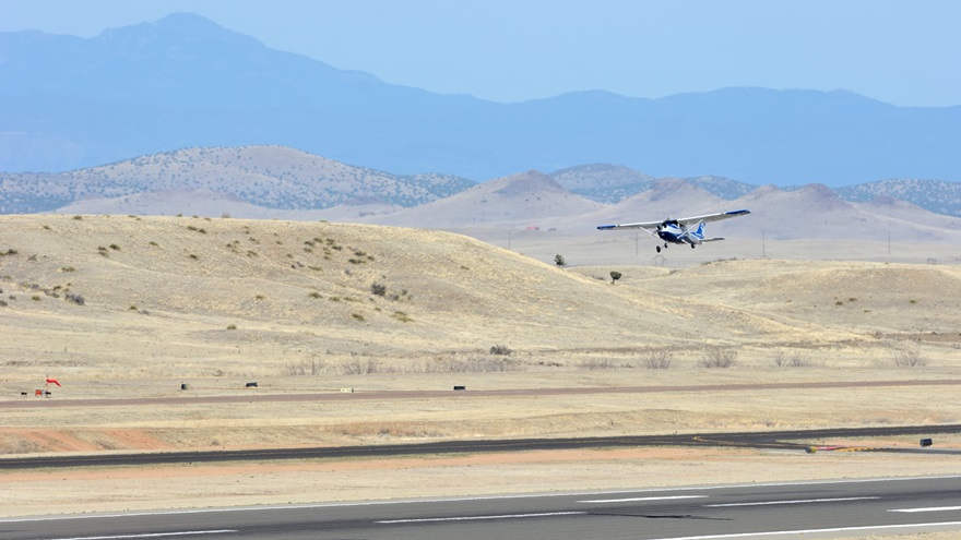 An Embry-Riddle Aeronautical University Skyhawk takes off from Runway 21L at Ernest A. Love Field in Prescott, Arizona. Granite Mountain, west of the airport, is 7,640 feet tall; other terrain in the area approaches 8,000 feet msl. Photo by Mike Collins.