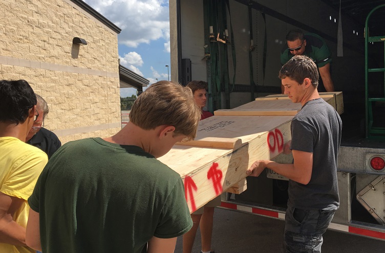 Dan Weyant's Georgetown, Texas, science, technology, engineering, and math high school students unload a crate of Van's Aircraft RV-12 parts for an aircraft build project. Photo courtesy of Dan Weyant.