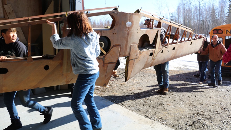 Nenana City School maintenance worker Paul Carattini and a dozen science, technology, engineering, and math students used a school bus to transport a Mooney Mite 200 miles from Wasilla to Nenana, where it will become a valuable teaching tool for the school's aviation program. Photo courtesy of Paul Carattini.