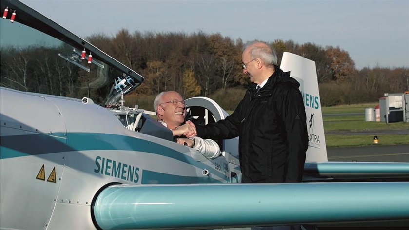 Frank Anton (right), who heads eAircraft for Siemens, congratulates pilot Walter Extra, who broke the world time-to-climb record on November 25. Photo courtesy of Siemens.