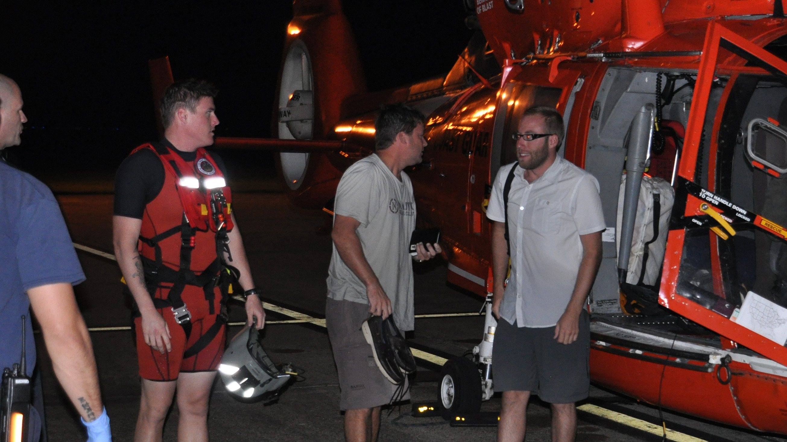 Pilot Theodore R. Wright III, far right, and passenger Raymond Fosdick, second from right, were rescued by the U.S. Coast Guard after ditching in the Gulf of Mexico. Both men now stand accused of fraud. Coast Guard photo. 