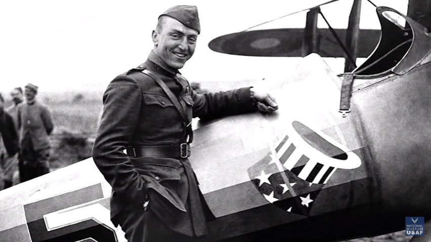Captain Eddie Rickenbacker poses with an aircraft bearing the emblem of the 94th Aero Squadron. Image courtesy of the National Museum of the U.S. Air Force via Youtube.