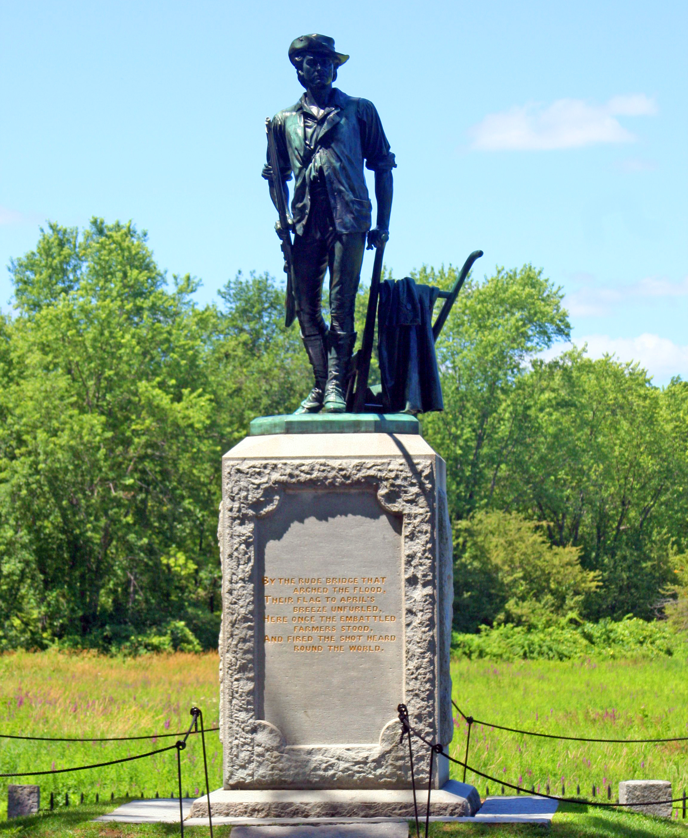 Beneath the Minute Man statue by Daniel Chester French is engraved the first stanza from Ralph Waldo Emerson’s Concord Hymn: “By the rude bridge that arched the flood; Their flag to April’s breeze unfurled; Here once the embattled farmers stood; And fired the shot heard round the world.” Photo by Dave Pape.