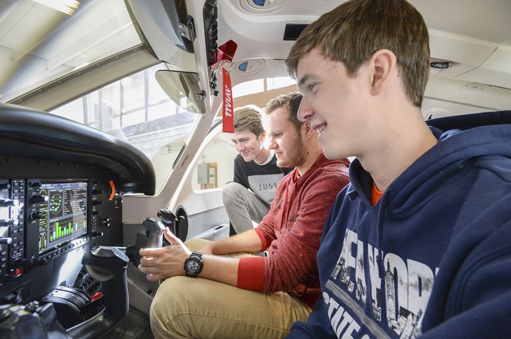 University of North Dakota students Body Graff, Luke Schurtz, and Max Lambrecht inspect the panel of a Piper Archer II training aircraft. Photo courtesy of Jackie Lorentz, University of North Dakota.