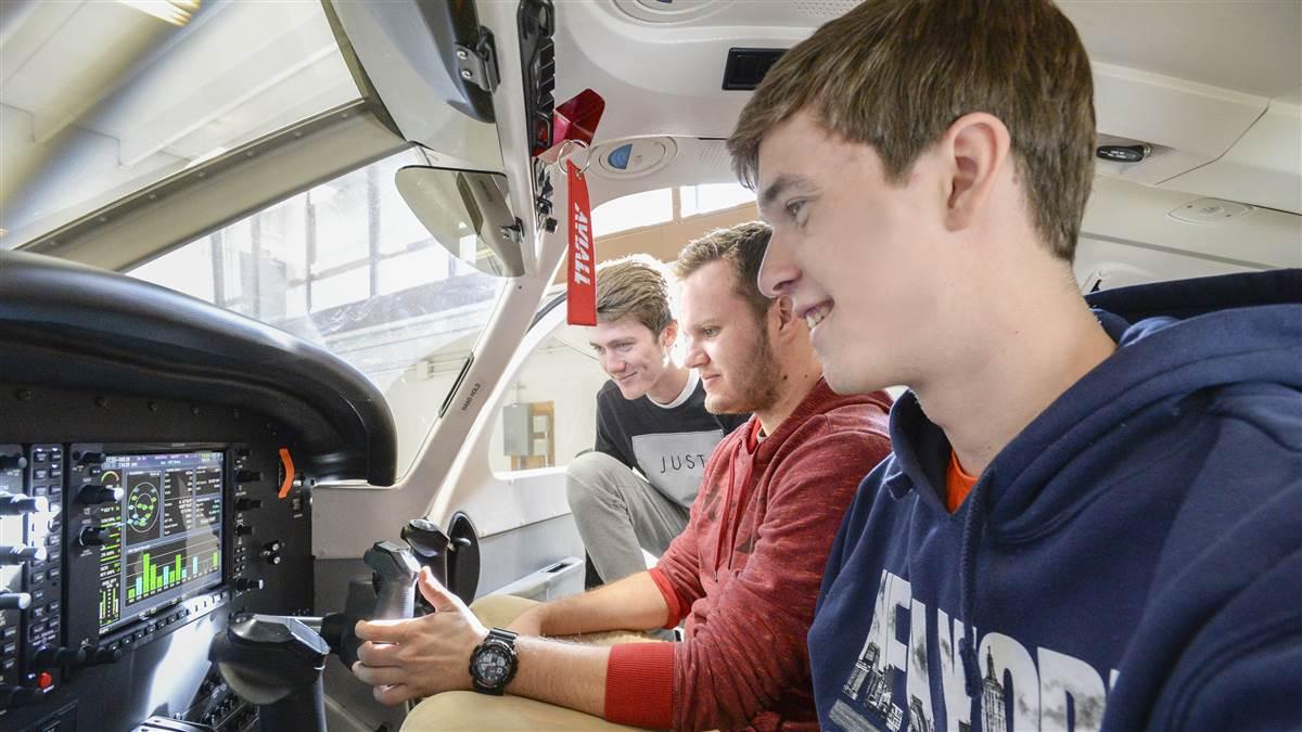 University of North Dakota students Body Graff, Luke Schurtz, and Max Lambrecht inspect the panel of a Piper Archer II training aircraft. Photo courtesy of Jackie Lorentz, University of North Dakota.