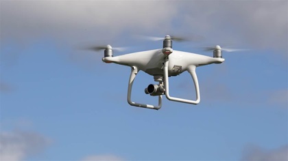 A DJI Phantom 4 in flight. The FAA requires all pilots, both commercial and hobbyists, to keep small, unmanned aircraft in sight at all times. Jim Moore photo.