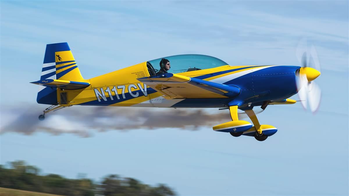 University of North Dakota aerobatic team coach Mike Lents turns on the smoke during an aerobatic routine in an Extra 300. Photo courtesy of Mike Lents, University of North Dakota.