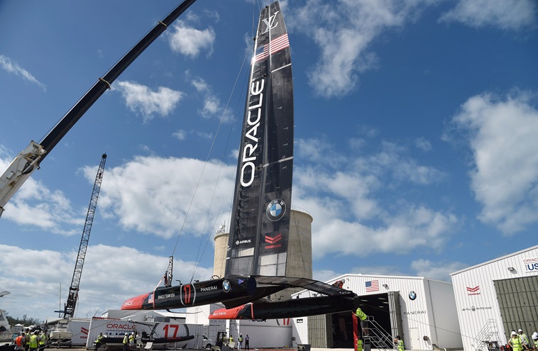 Aviation-inspired attitude control systems help regulate the rigid airfoil sailing wings, main sail, flaps, and twin underwater elevators shown on Oracle Team USA's America's Cup catamaran as it's lifted toward the water for the first time in Bermuda, Feb. 15. Photo by David Tulis.