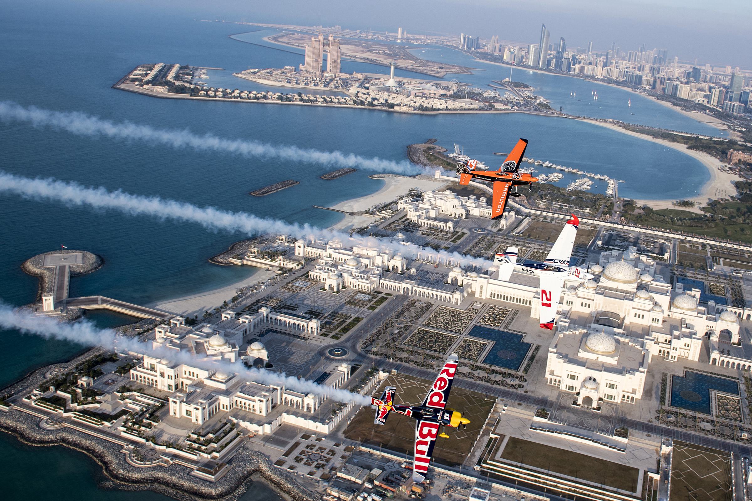 Defending Red Bull Air Race World Champion Matthias Dolderer of Germany leads fellow pilots Nicolas Ivanoff of France and Martin Sonka of the Czech Republic on a pre-race flight over the new 160,000-square-meter Presidential Palace in Abu Dhabi, United Arab Emirates, Feb. 6. Photo by Predrag Vuckovic/Red Bull Content Pool.
