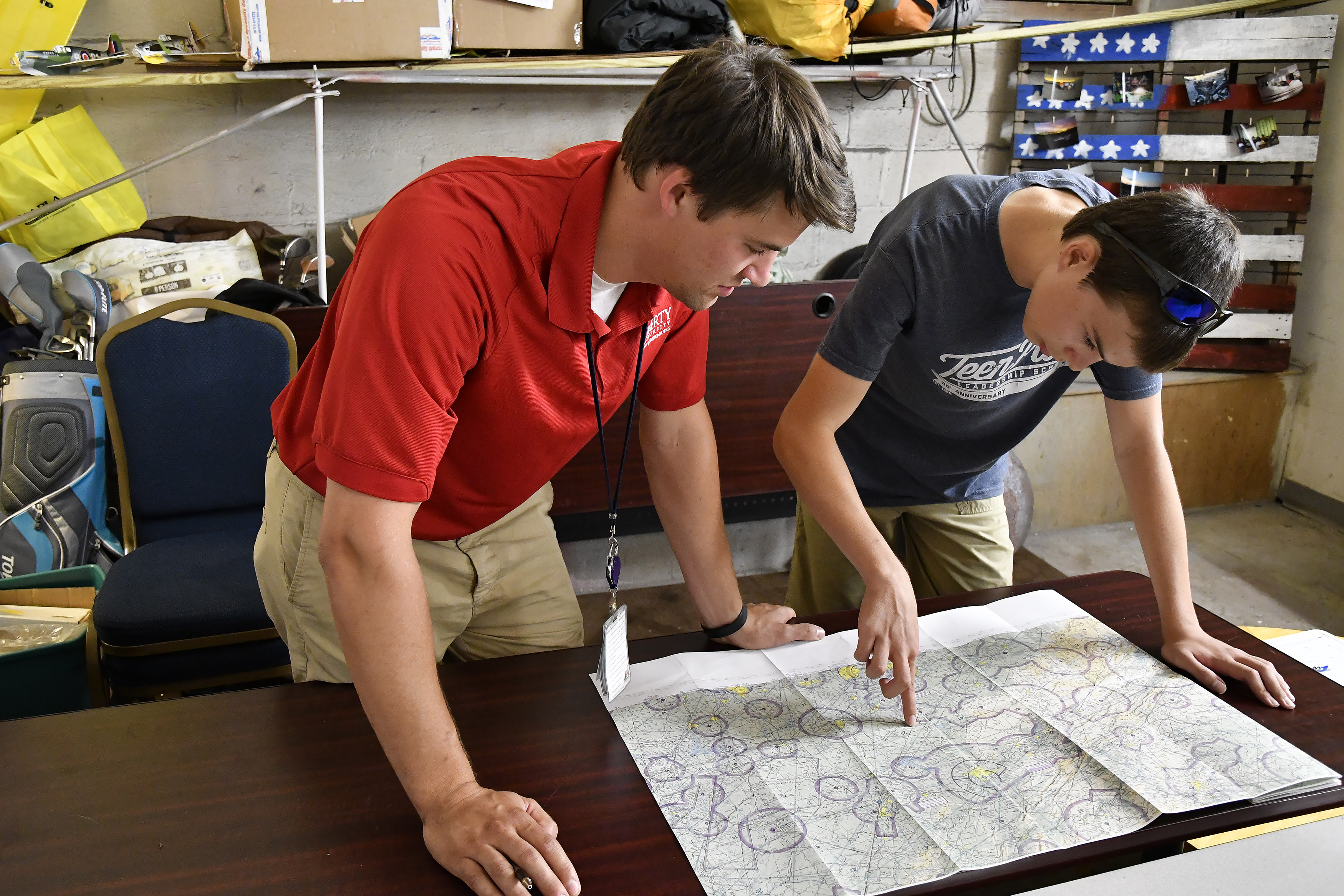 Instructor John Adams coaches student Timothy Cashman on chart skills at an informal New London Airport classroom in Lynchburg, Virginia. Photo by David Tulis.