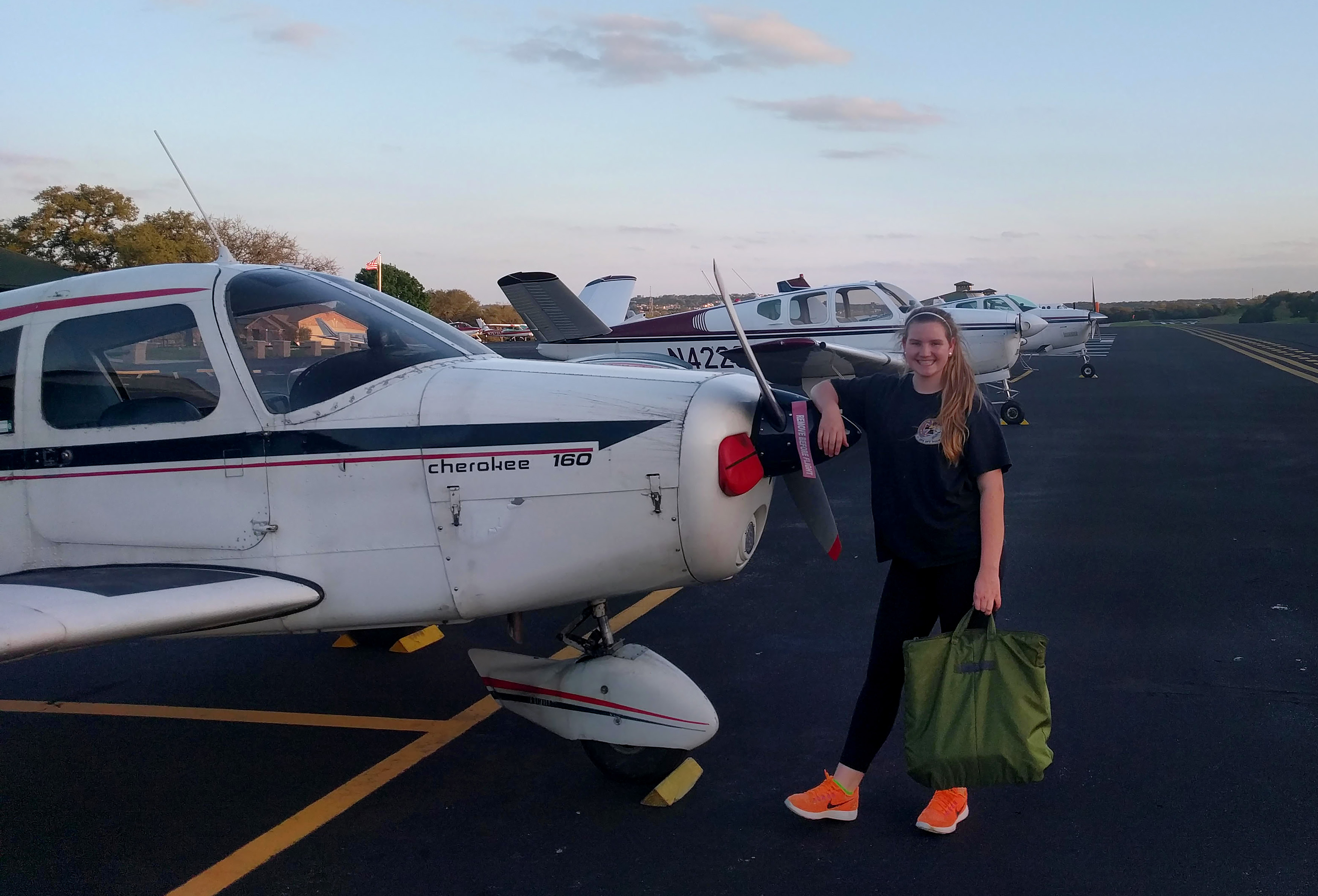 Student pilot Lauryn Spinetta with the Piper Cherokee PA-28 160 she is using for flight training. Photo courtesy of Lauryn Spinetta.