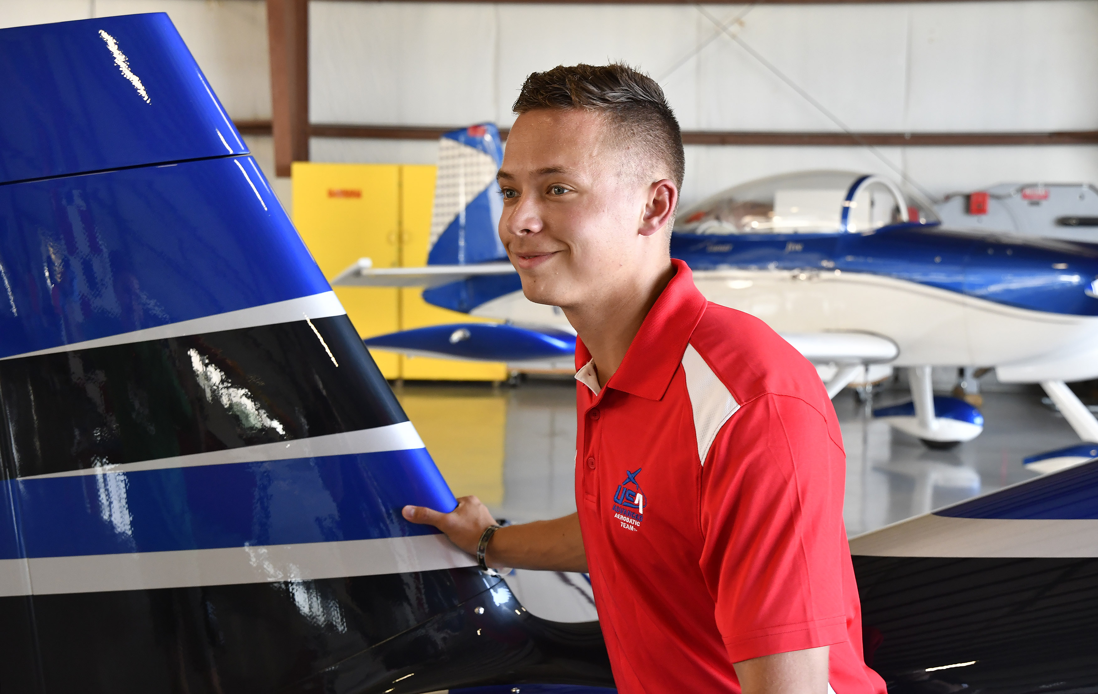 Cameron Jaxheimer, an Endeavor Air commercial pilot and aerobatic performer, moves an Extra 300 during EAA AirVenture. Photo by David Tulis.                                      