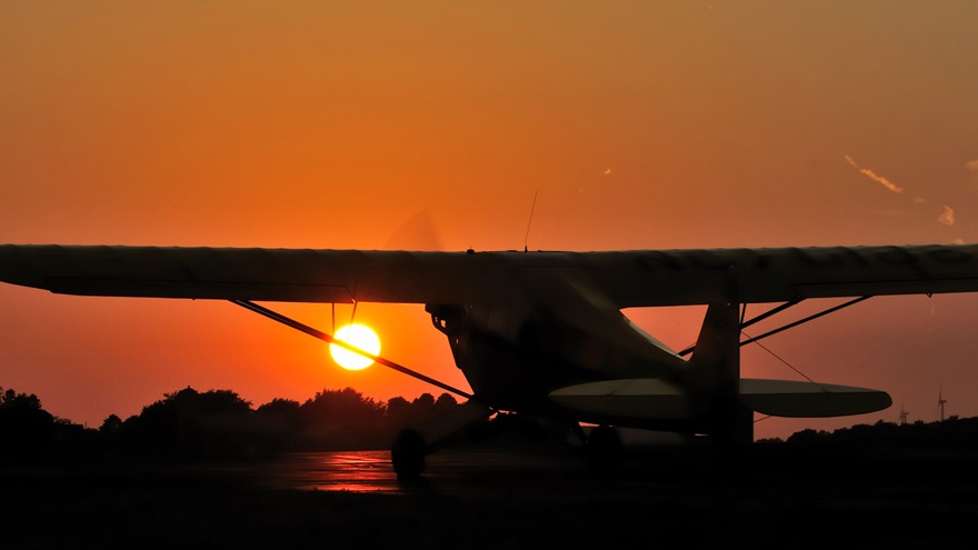 A Piper Cub taxis at sunset in Hartford, Wisconsin, the evening before the July 22, 2012, Cubs2Oshkosh flight commemorating the Piper J-3 Cub's 75th anniversary. Photo by Mike Collins. 