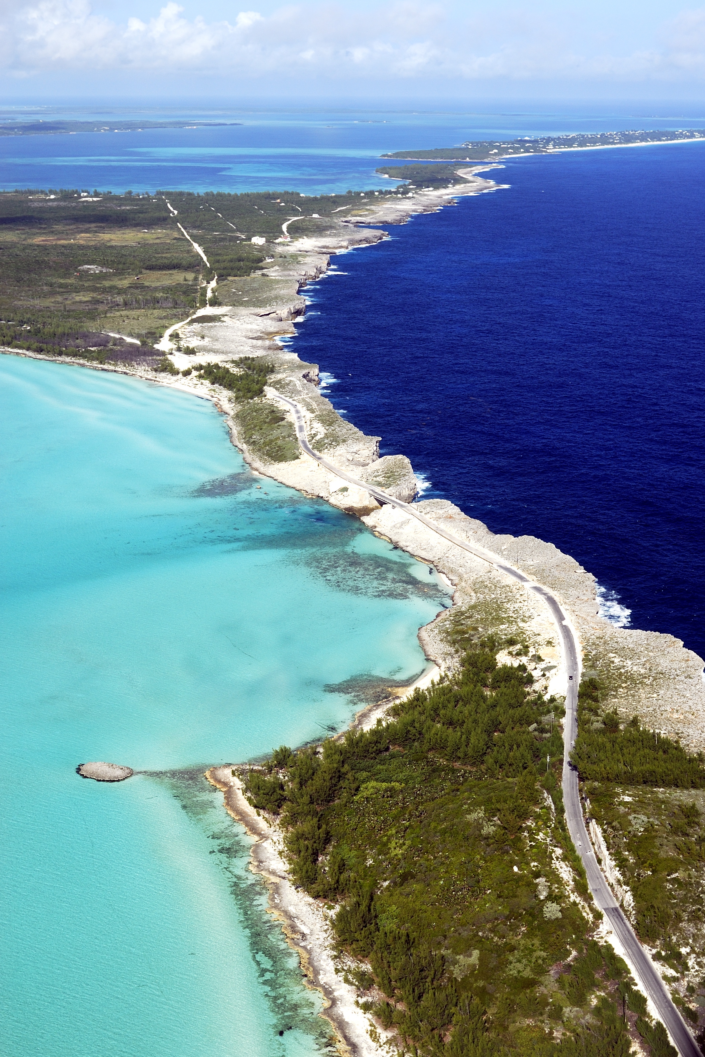 The contrast between deep, dark Atlantic Ocean waters and shallow, light turquoise waters of the Bahamas Bank is evident in this aerial of Eleuthera Island. Photo courtesy Bahamas Ministry of Tourism.