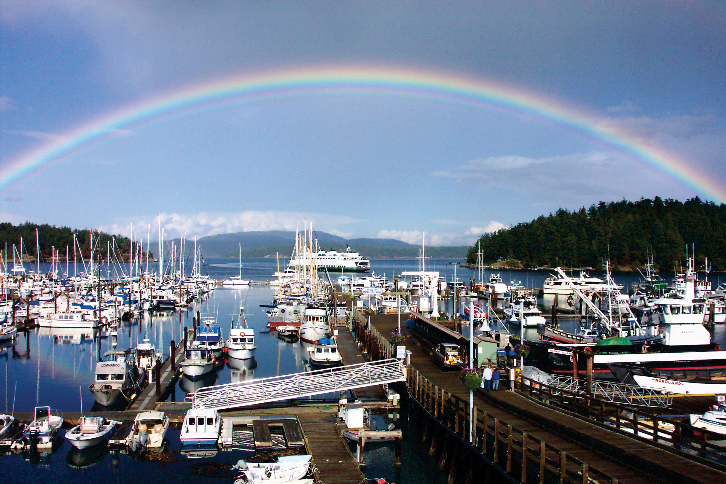 A rainbow arcs over Friday Harbor, on San Juan Island. Walk here from the airport to shop, dine, or board a whale watching tour. Photo courtesy San Juan Islands Visitors Bureau.