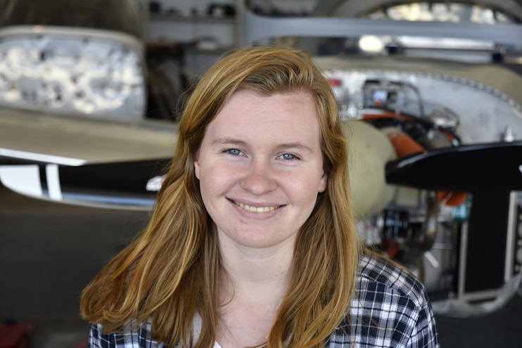 Stratus Aviation Foundation mentor and University of Delaware civil engineering junior Kiera Crenny helped construct the Van's Aircraft RV-12 behind her. She began her affiliation with the Philadelphia-based program as a high school junior. Photo by David Tulis.