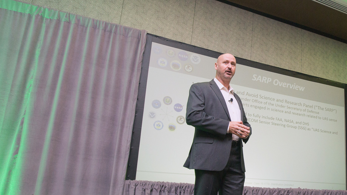 Dallas Brooks delivers a presentation on collaborative research aiming to achieve safe integration of drones with manned aircraft at AUVSI Xponential on May 8. Jim Moore photo.