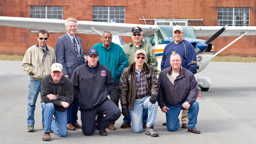 The New River Flying Club of Beckley, West Virginia is celebrating 50 years aloft. Members attending a March club meeting included (standing, left to right) Terry Treadway, Ray Lambert, Homer Smith, Jody Clowers, Mike Pedri; and (kneeling, left to right) Carl Hansen, Bo Cook, past President Scott Durham, and President Gary Patterson. Photo courtesy of Frozen Moments Photography.