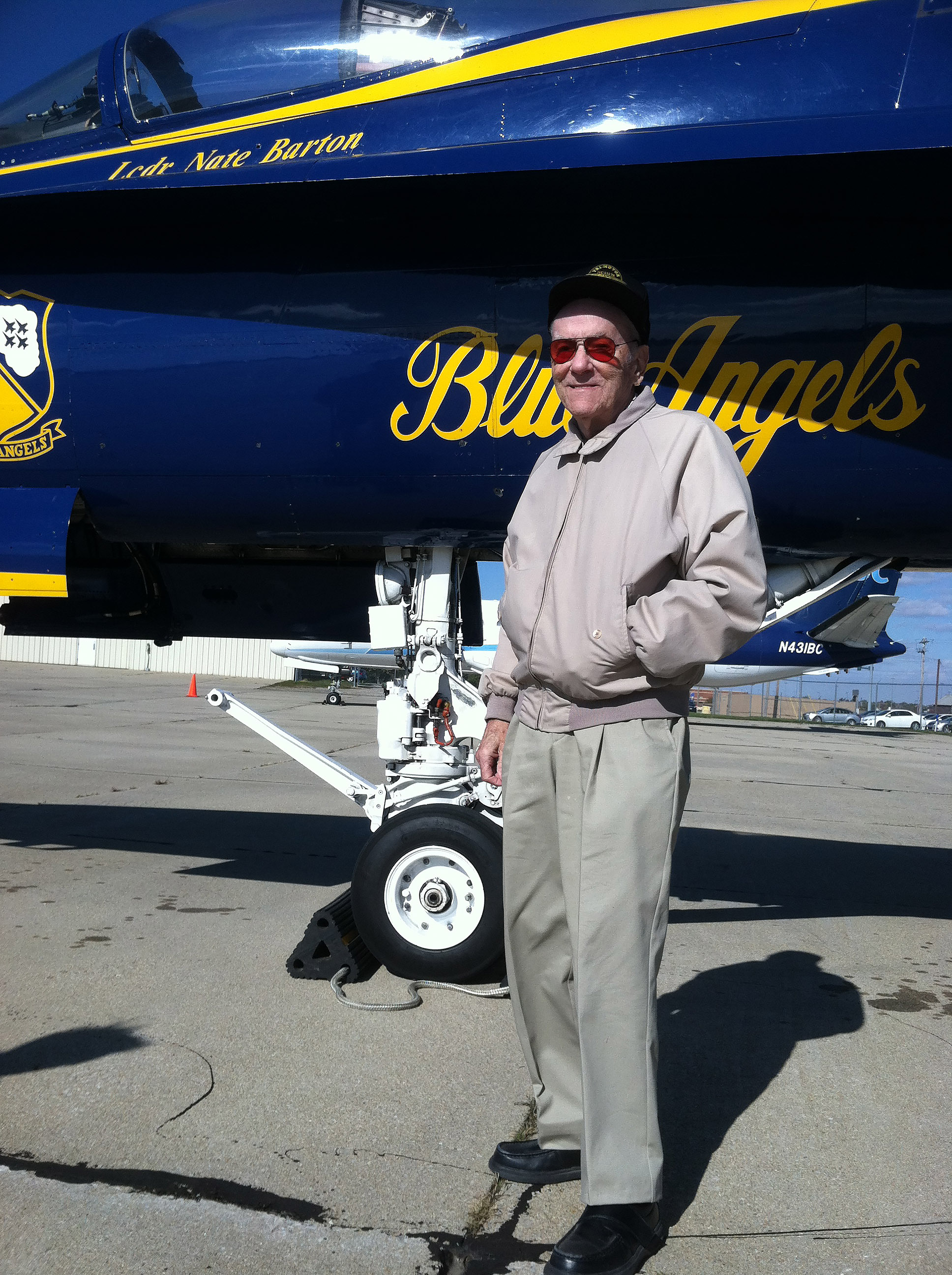 Pilot and Wisconsin aviation entrepreneur Bill Brennand, who helped establish EAA AirVenture's popular Seaplane Base, stands near a Blue Angels navy jet. Photo courtesy of Jim Cunningham.