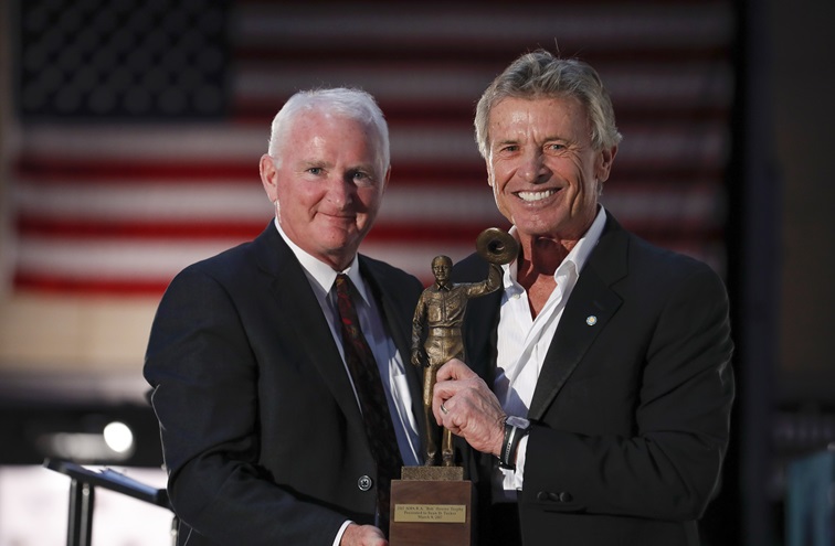 Aerobatic pilot Sean D. Tucker holds the 2017 R.A. 'Bob' Hoover Trophy awarded to him by AOPA President Mark Baker during the second annual Bob Hoover Trophy Reception. Photo by Chris Rose.