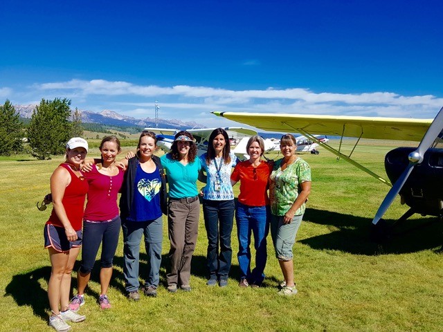 Christina Tindle (center, in blue shirt) will host a weekend of backcountry flying designed for women in Idaho in July. This photo is from the 2016 WomenWise Airmanship Adventure in Smiley Creek, Idaho.