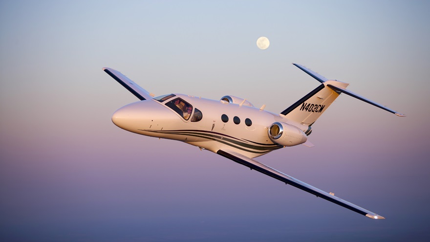 AOPA Senior Photographer Mike Fizer photographs the Cessna Mustang southwest of Wichita with a full moon.