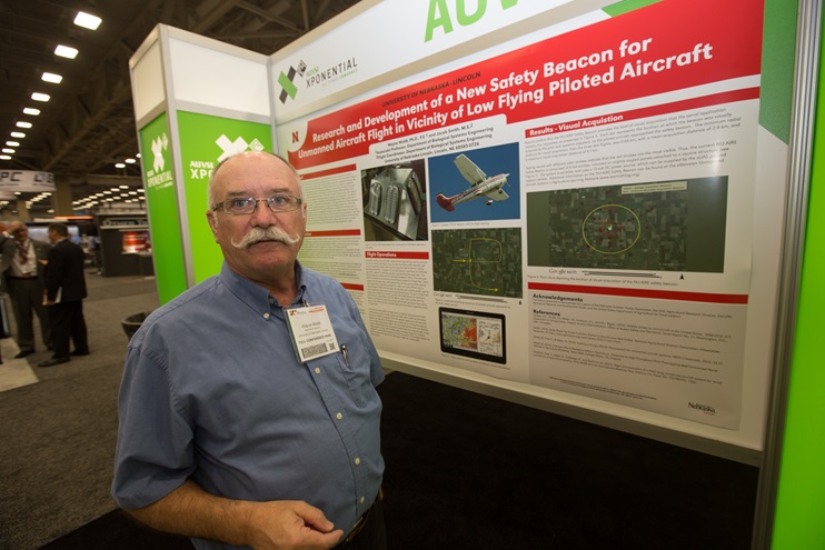 Associate Professor Wayne Woldt of the University of Nebraska, Lincoln, came to AUVSI Xponential hoping to attract interest in producing a strobe light system designed to warn agricultural aircraft pilots and other low-altitude manned operators of the presence of unmanned aircraft. Photo by Jim Moore.