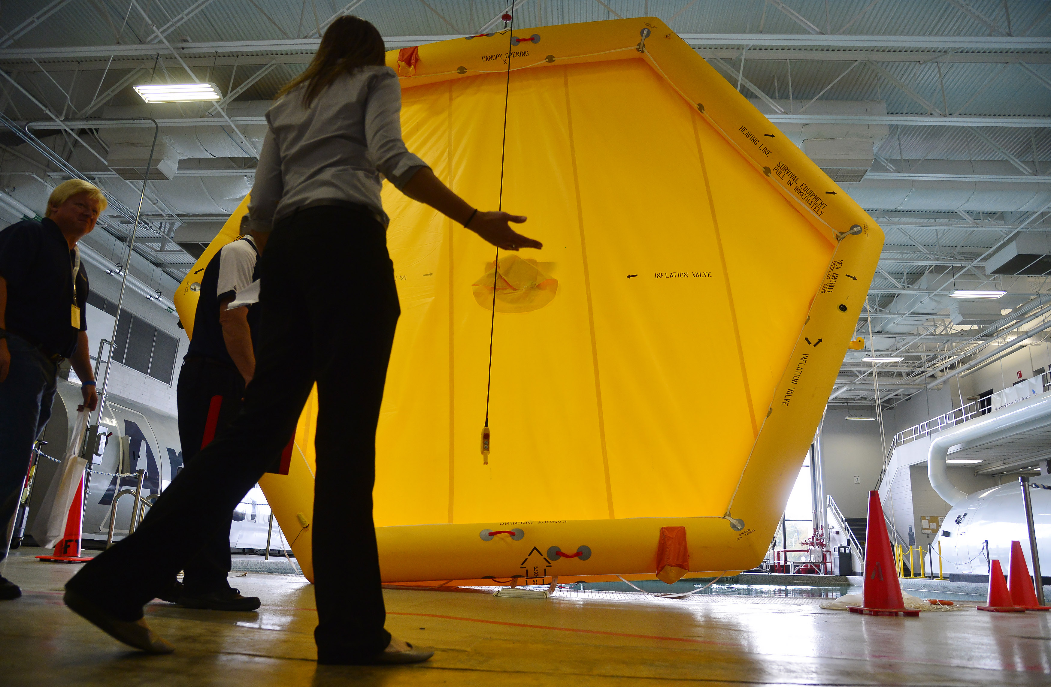 American Airlines pilot career development analyst Amy Boger leads a tour of the airline's emergency training facility during the AOPA High School Aviation STEM Symposium in Forth Worth, Texas, Nov. 6. Photo by David Tulis.