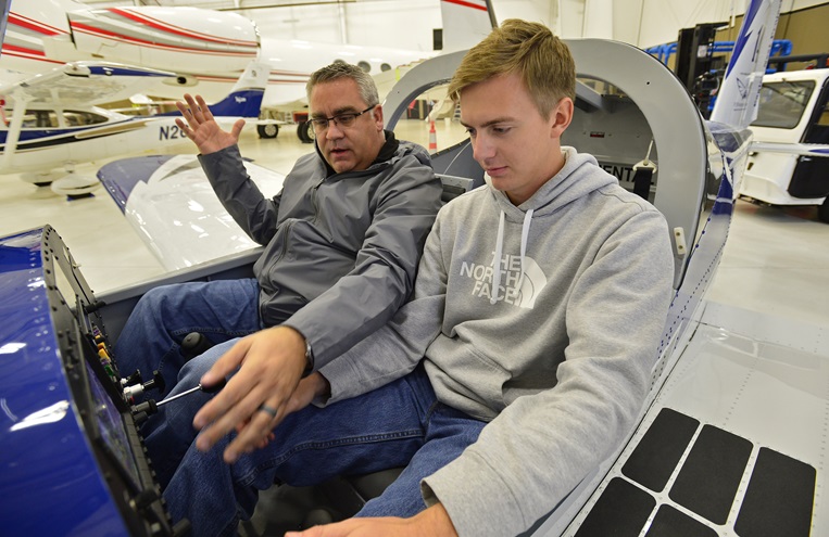 Phillip Campbell familiarizes a Van's Aircraft RV-12 cockpit with McKinney High School student Bryan Soltys-Niemann during an aviation class at McKinney National Airport in McKinney, Texas, Nov. 8. Photo by David Tulis.

