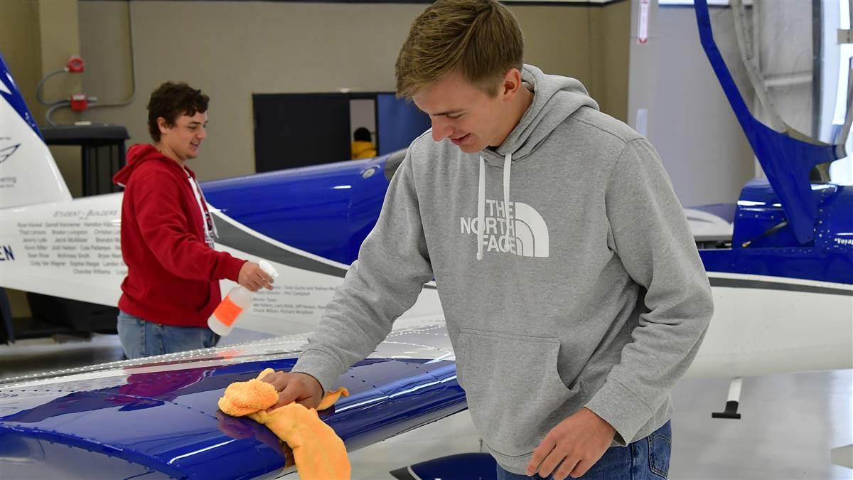 McKinney High School students Bryan Soltys-Niemann and Sean Rose clean a Van's Aircraft RV-12 they helped construct during an aviation class at McKinney National Airport in McKinney, Texas, Nov. 8. Photo by David Tulis.