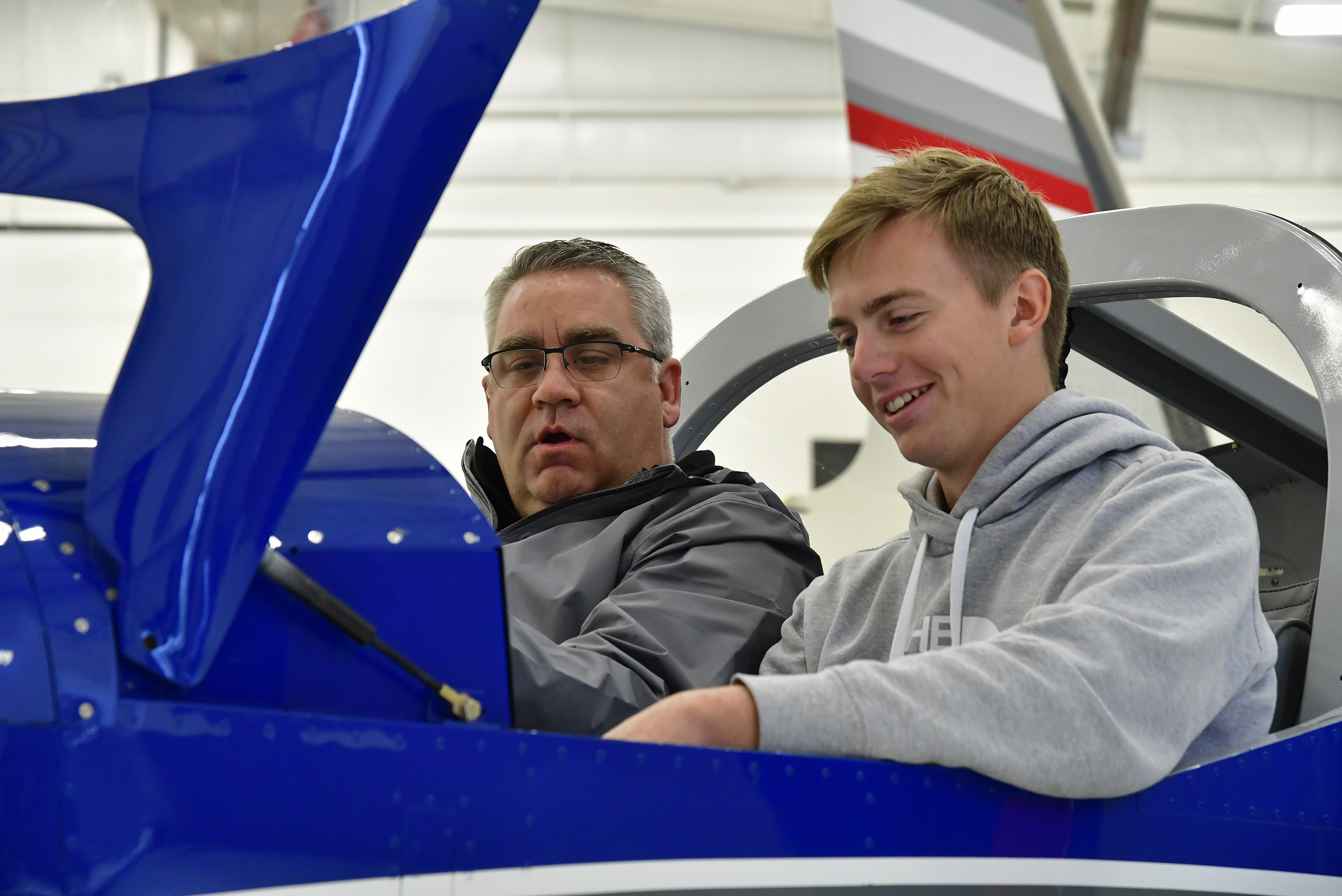 Phillip Campbell familiarizes a Van's Aircraft RV-12 cockpit with McKinney High School student Bryan Soltys-Niemann during an aviation class at McKinney National Airport in McKinney, Texas. Photo by David Tulis.