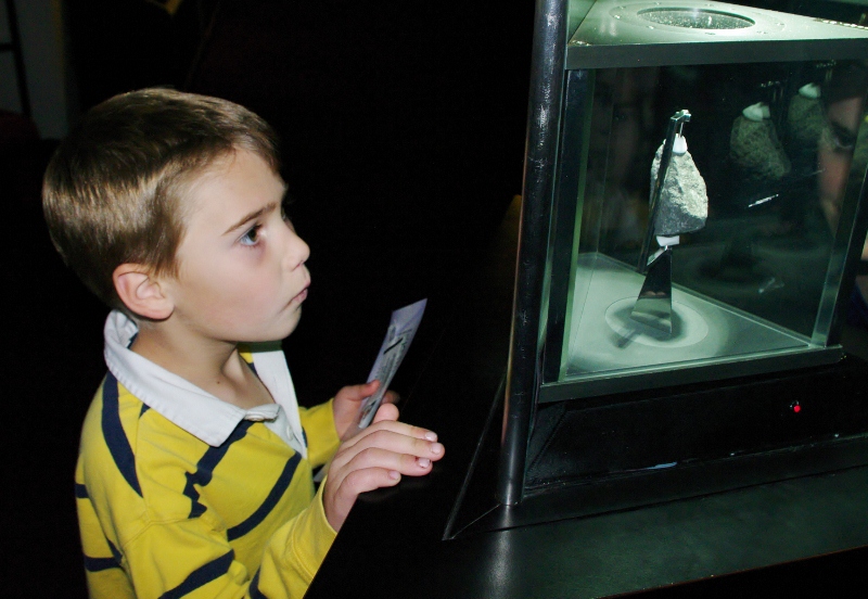 A young visitor gazes at a Moon rock at the Cosmosphere in Hutchinson, Kansas. Photo courtesy Kansas Tourism.