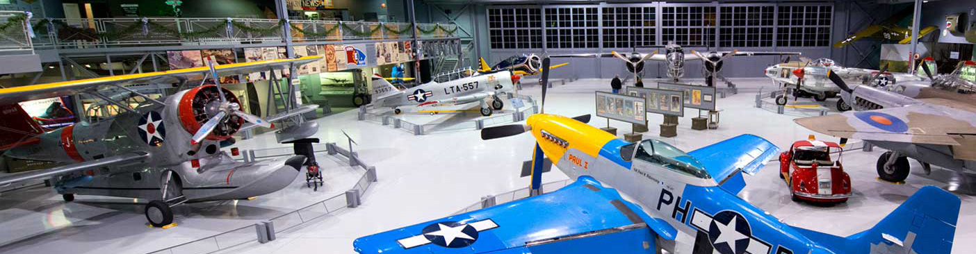 A P-51, Grumman Duck, and other warbirds fill the Eagle Hangar at the EAA Aviation Museum in Oshkosh, Wisconsin. Photo courtesy EAA.