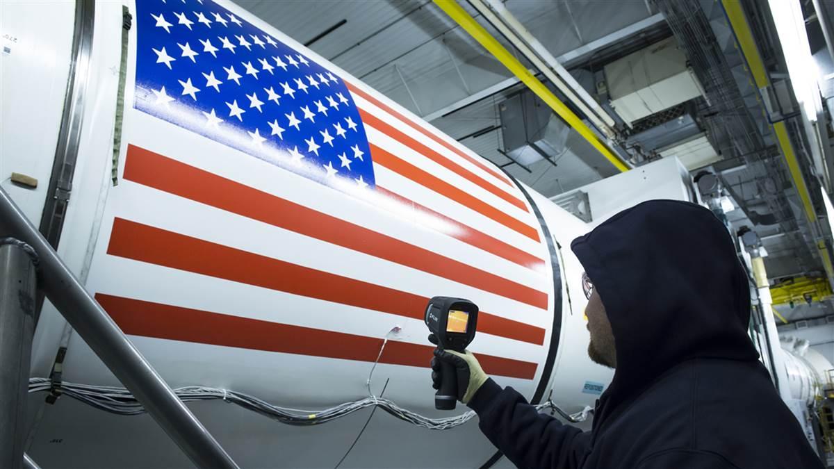 An Orbital ATK technician checks the temperature of a full-scale, test version booster for NASA's Space Launch System. Photo courtesy of Orbital ATK/NASA.