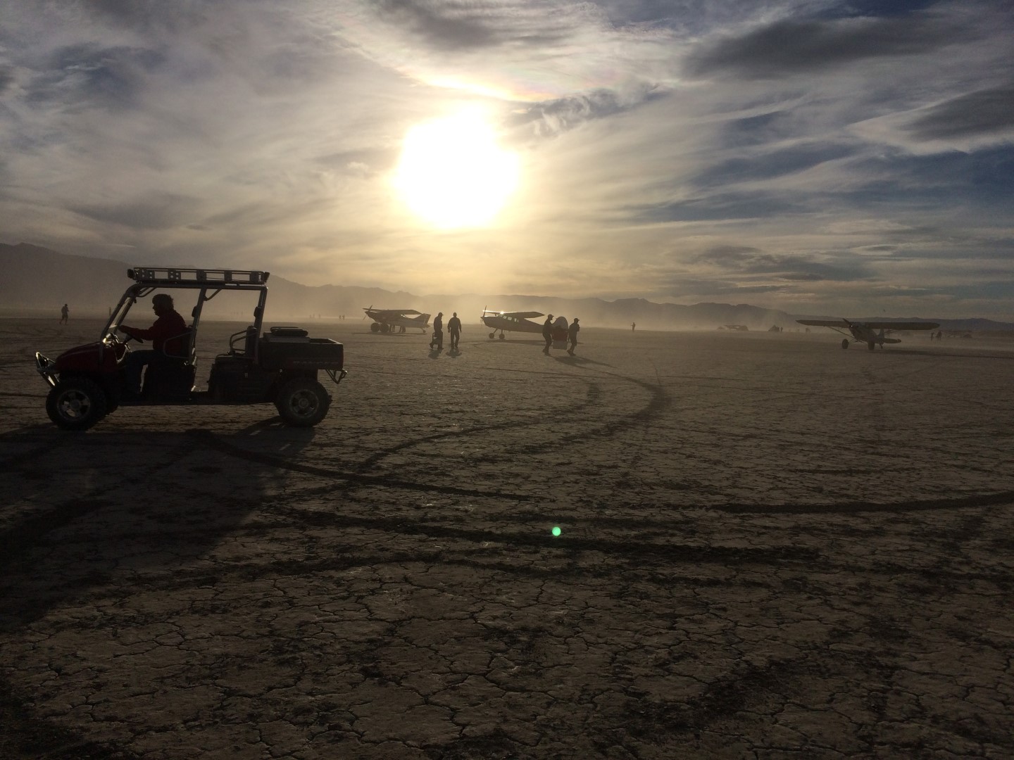 Winds or prop wash kick up playa dust, but that’s part of being out in the desert. Not everyone flies in; some people drive in with RVs, pickups, or trailers that also pack golf carts or ATVs. Photo by Nadine Burak.
