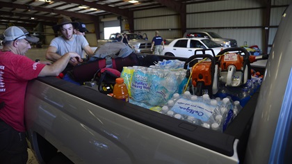 Members of Task Force 75, veterans of the U.S. Army's 75th Ranger Regiment, load up chain saws, water, and staple items inside a Sun 'N Fun International Expo hangar at Lakeland Linder Regional Airport for delivery to Hurricane Irma victims Sept. 13. Photo by David Tulis.