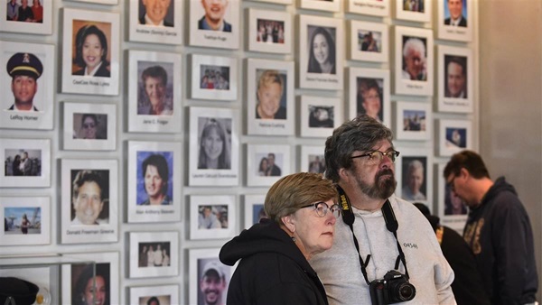 Harold and Janice Ulmer are framed by the faces of 40 passengers and crew honored at the Flight 93 National Memorial near Shanksville, Pennsylvania. The ordinary citizens are considered heroes for their courage confronting terrorist hijackers aboard a transcontinental flight that originated in Newark, New Jersey, bound for San Francisco, on Sept. 11, 2001. Photo by David Tulis.