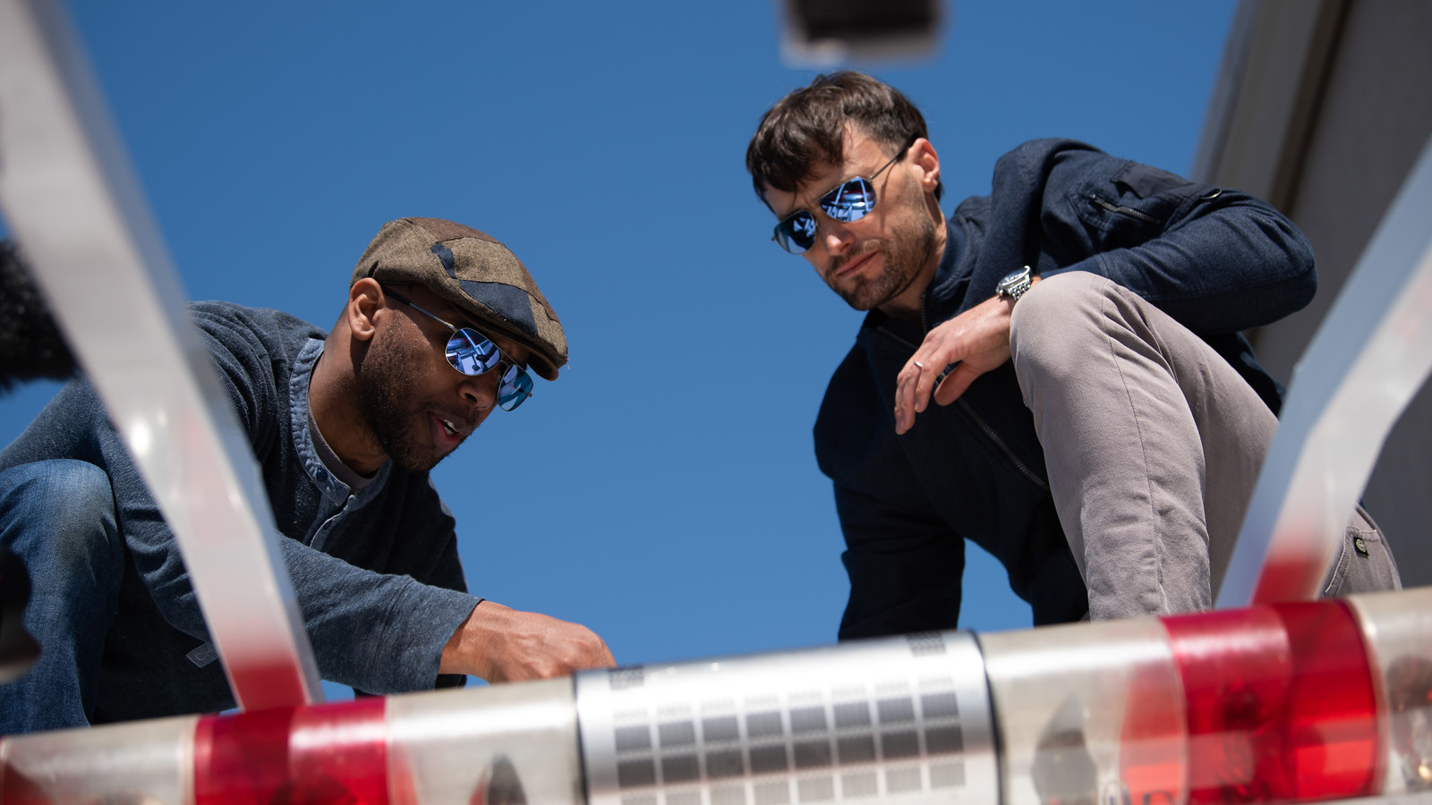 Mike Tyson (left) and  Eric Tucker (right) examine the roottop platform before Tucker attempts to land his J-3 Cub. Photo courtesy of Method Seven and Donald Beirdneau.