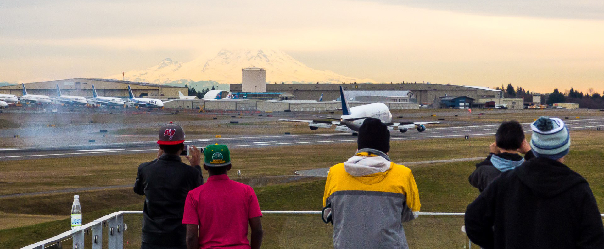 Visitors on the Future of Flight Strato Deck watch as a Dreamlifter lands at Paine Field. The Dreamlifter is specially designed to transport huge, prefabricated parts of the 787 Dreamliner that are manufactured elsewhere (such as the wings), and deliver them to Paine Field for final assembly. Joe Kunzler photo.