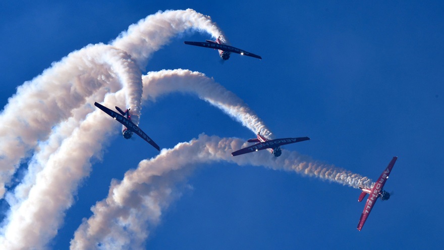 The AeroShell Aerobatic Team executes a break as they come out of the top of a loop at the Sun 'n Fun International Fly-In and Expo in Lakeland, Florida. Photo by Mike Collins.