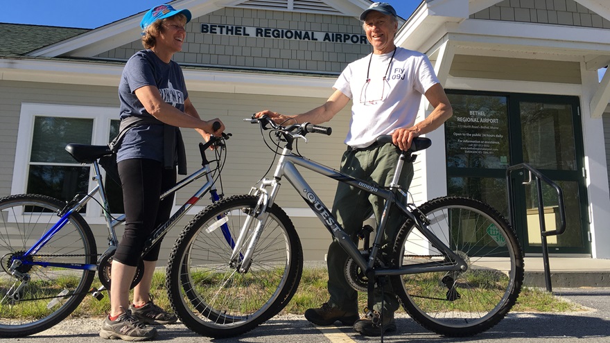 Maine Aeronautics Association President Lisa Reece and her husband Steve Williams bike at Maine’s Bethel Regional Airport, one of the airports where bicycles have been made available to pilots. Photo courtesy of Lisa Reece.